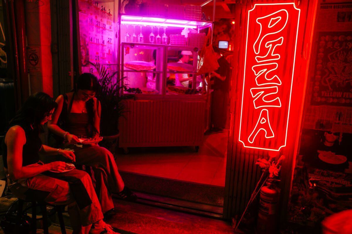 Red neon PIZZA sign inside