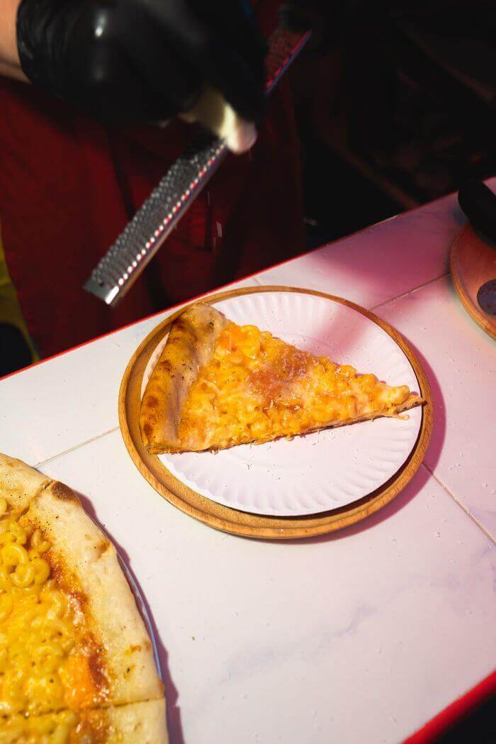 A single slice on a paper plate