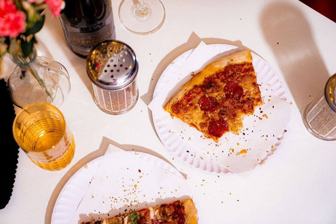 Pizza spread with drinks on the table