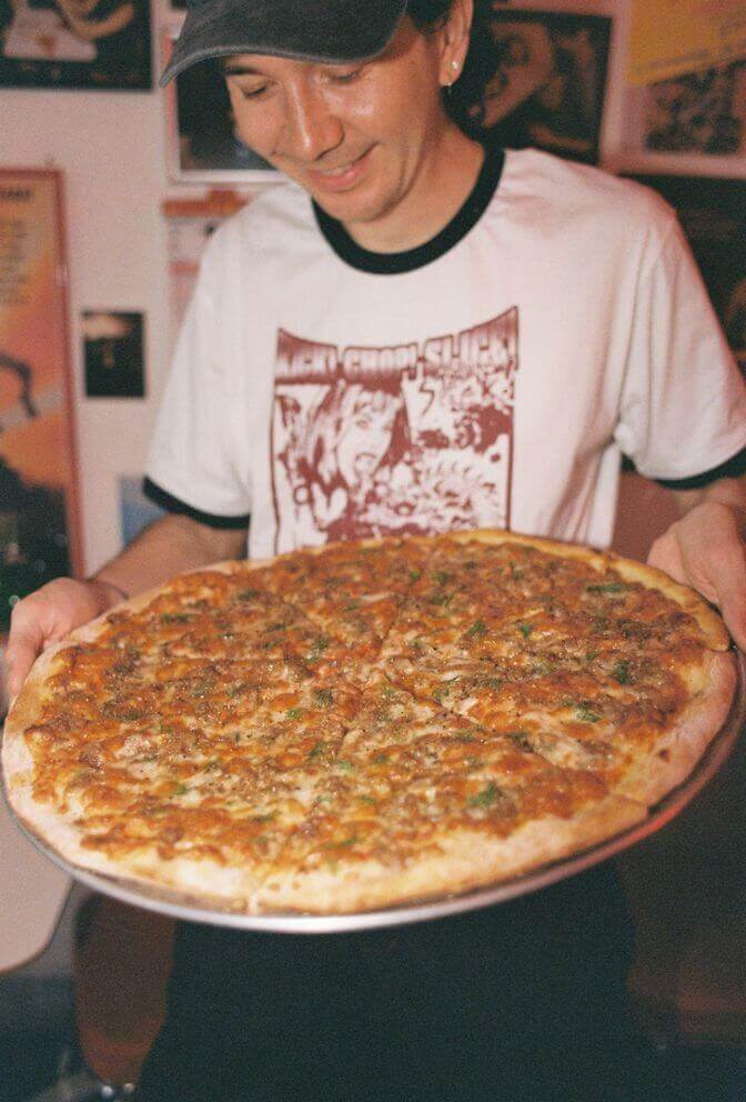 Whole pizza held up